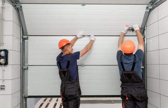 Workers,Are,Installing,Lifting,Gates,Of,The,Garage.